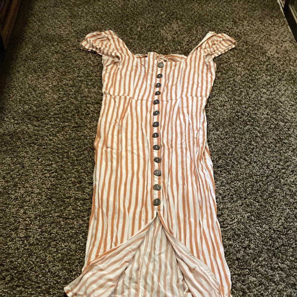 It is a long dress with a opening in the front and on the back.